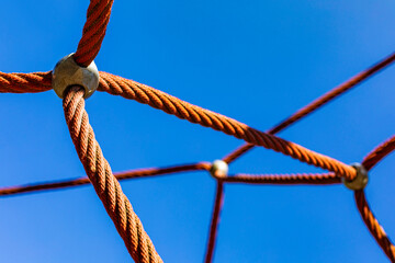 Playground ropes against clear blue sky