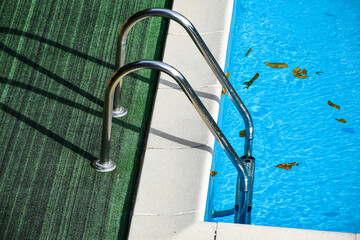 View of the swimming pools from the hotel terrace. Leaves in the pool
