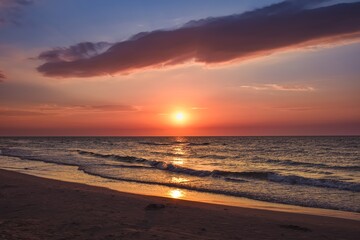 Beautiful colorful sunset over the sea. Sandy beach in the evening on the Polish Baltic Sea. - 657007142
