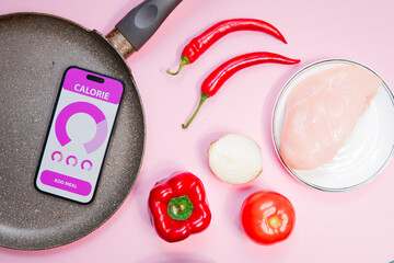 calorie counting application on phone screen on pink background. Fat lay photo showing healthy food, rich in protein.