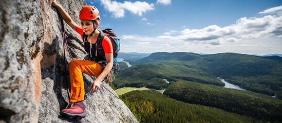 Woman determined to do rock climbing in the mountains - obrazy, fototapety, plakaty