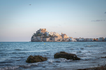 Fototapeta premium Sunset in Peñíscola, Spain, with a view of the old town, wall and castle on the Mediterranean Sea.