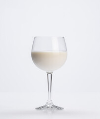 goblet full of fresh milk on a white background