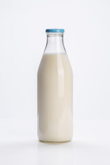 fresh milk in glass bottle on white background