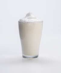 fresh milk with foam in glass cup on white background