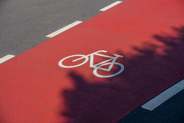 bicycle icon road marking on a red bike lane on a street in the city