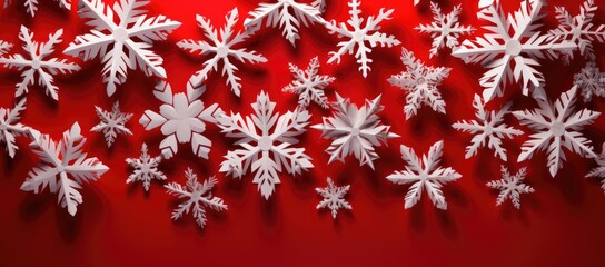 Naklejka na ściany i meble Cut-out paper snowflakes against a red backdrop