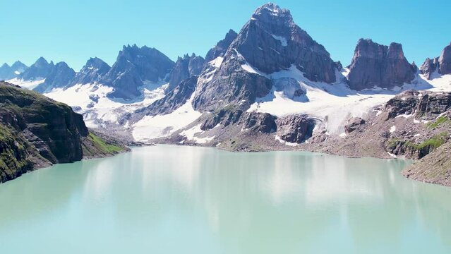Lake reflecting mountain cliffs in Chitta Katha Lake, Neelum Valley, Kashmir, Himalayas