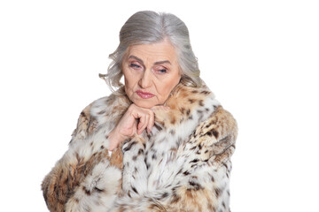 portrait of sad beautiful senior woman in fur coat