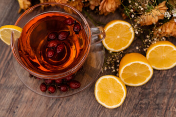 A cup of tea with rosehip and lemons. Healthy lifestyle. Folk methods