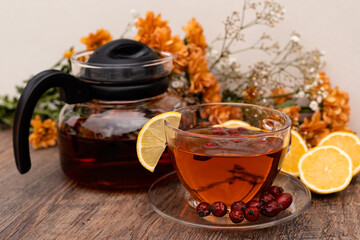 Rosehip tea in a clear teapot and cup. Autumn vitamins for health