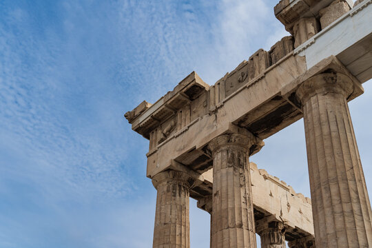 Greek columns in the Parthenon against the sky, close-up photo.