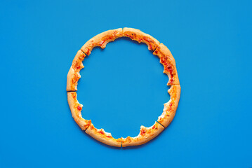 Pizza crust leftovers top view on a blue background