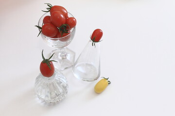 red tomatoes in a glass bowl, tomatoes in a glass on the table, vegetables in the kitchen, tomato harvest, tomatoes on a white background, tomato still life