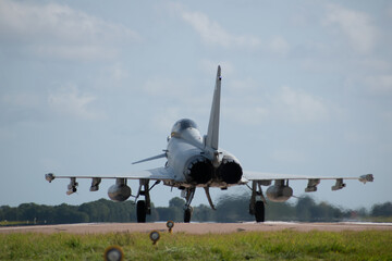 raf military typhoon aircraft ready to take off, heat distortion lining up with landing lights...