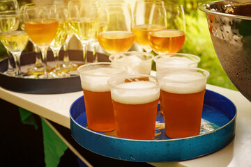 The set of plastic beer glasses on a tray.