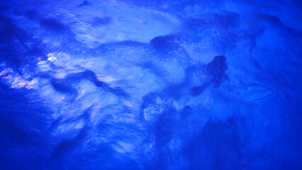 Night shot with copy space of led illuminated jacuzzi pool full of healthy bubbles of water...