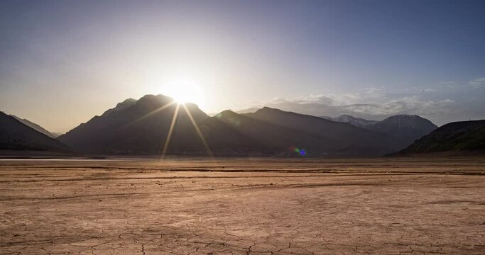 sunrise in surreal drought cracked landscape Timelapse, lack of freshwater global warming climate change concept, Cracked soil in a desert dry land , ecological issues, water crisis concept