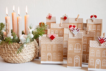 Handmade advent calendar. Houses shaped carton gift boxes. Eco friendly Christmas gifts diy concept