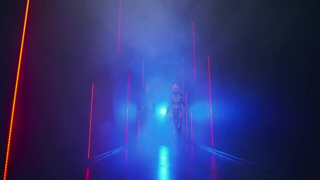 Fantasy cyborg woman creative robot costume glowing glasses metal body cyberpunk style braid hairstyle. Sexy alien girl in virtual reality game lady warrior future holding vr laser sword in hands. 4k