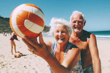 An elderly couple playing volleyball on the beach - obrazy, fototapety, plakaty