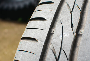 Tire tread wear indicator, Close up of tire with tire tread wear indicator showing on tread...