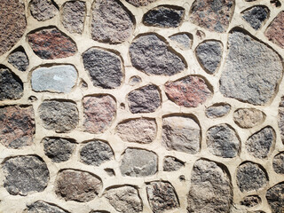 wall of a building consisting of stones of different sizes and colors