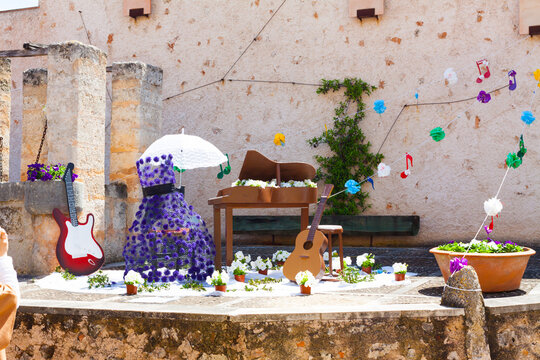 Decoration, consisting of two guitars, a piano and a violet dress with some musical notes on the background, on "Costitx en Flor" (Costitx in bloom) Flower Fair, Majorca, Spain