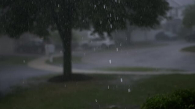 Hard storm, with loud thunder and lightning, a suburban residential street . slow motion footage