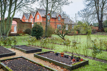 UK house and garden in winter with empty vegetable patch