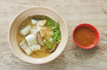 boiled rice with bass fish and mushroom in clear soup on bowl dipping spicy sauce