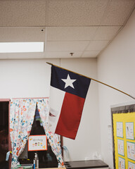 Proudly display of Texas flag in pre-kindergarten classroom near Dallas, modern preschooler class...