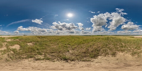 spherical 360 hdri panorama among dry grass farming field with clouds on blue sky in...
