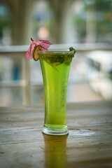 Apple mojito with mint and ice on the blue background,