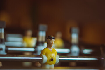 A foosball table is a recreational game symbolizing entertainment, skill, and socializing. It represents teamwork, competition, and the joy of play, and is often associated with bar and culture