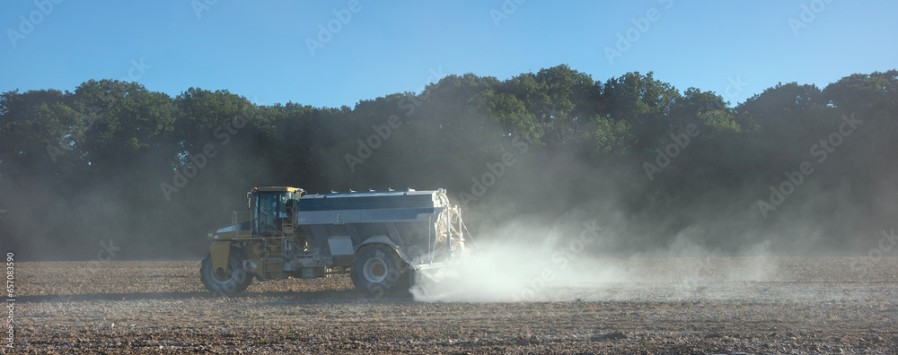 Poster truck spreading lime on agricultural field in france