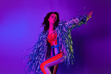 Photo of shiny dreamy girl dressed glitter jacket dancing oldschool discotheque isolated gradient violet color background