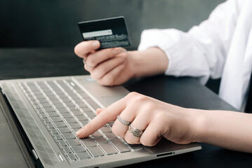 Convenience of Online Shopping. Woman's Hands, Credit Card, and Laptop. Seamless Online Buying. Woman's Hands with Credit Card and Laptop