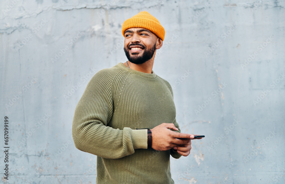 Poster cellphone, smile and young man by wall networking on social media, mobile app or the internet. techn