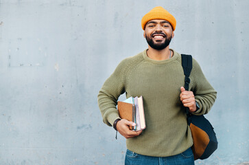 Student, portrait and backpack for education, learning and smile for university or college on a wall background. Happy young, african man with books, bag and ready for scholarship, study or research