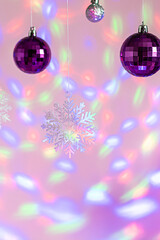 Magic Cristmas composition with traditional shining decorations and snowflakes on light pink...