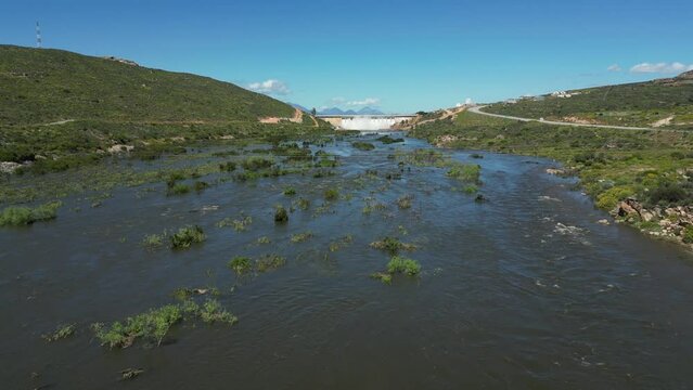 Fly up the Olifants River toward Clanwilliam Dam wall with all sluice gates open
