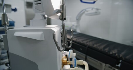 Close up of advanced equipment for surgery in operating room of modern hospital. Tubes of life support or general anesthesia machine standing in bright operating block in clinic or medical facility.