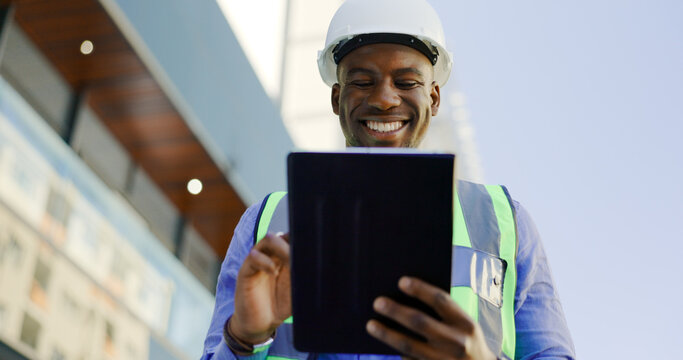 Engineering, man and tablet at construction site inspection, building development and industrial renovation. Excited or happy african worker on digital tech, design software or architecture planning