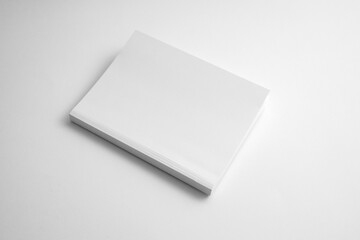 Mockup of white book, notebook, copybook, blank notepad cover  on white background. Layout mock up ready for your design preview.