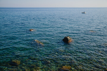 Sea view from above. Stones and blue clear water