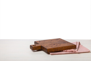 Cutting board with napkin on wooden table with isolated background.Handmade cutting board wood cutting board. Wooden board on a white background. MOCKUP. Design.