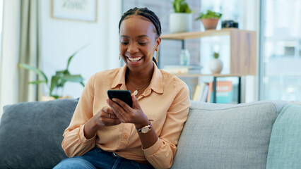 Fototapeta premium Happy black woman, phone and social media on sofa in relax, communication or networking at home. African female person smile, laughing or mobile smartphone for funny joke or meme on couch in house