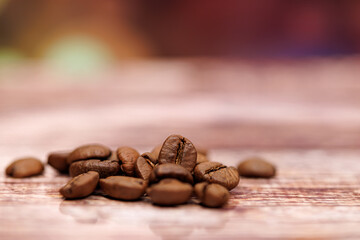 A handful of coffee beans on a blurred background.  Coffee beans on the table.