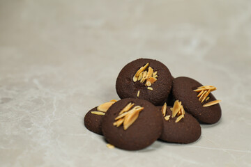 Chocolate cookies biscuits topping with peanut served on background side view of bakery item